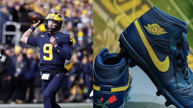 Michigan Wolverines quarterback J.J. McCarthy next to his navy Air Jordan cleats.